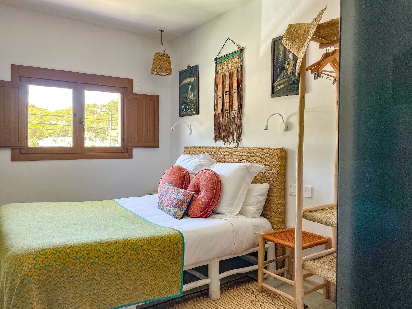 A bedroom with a bed , a window and a chair.