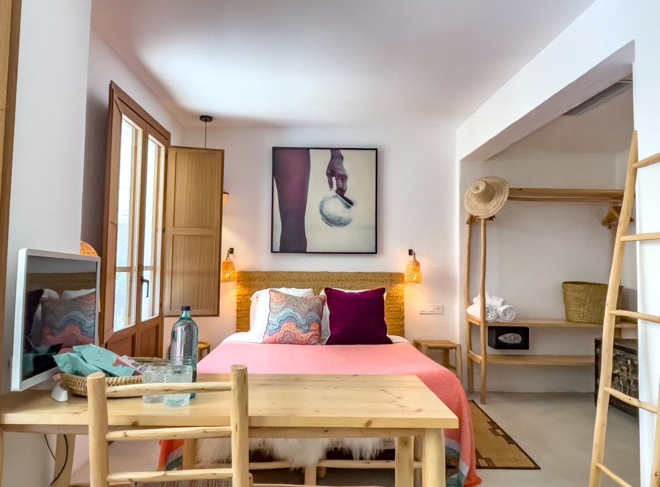 A bedroom with a bed and a wooden table