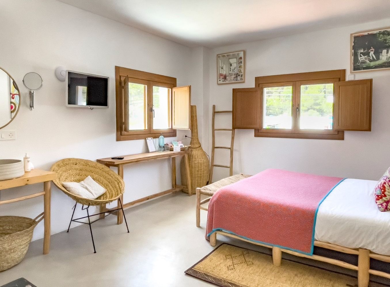 A bedroom with a bed , chair , desk and mirror.