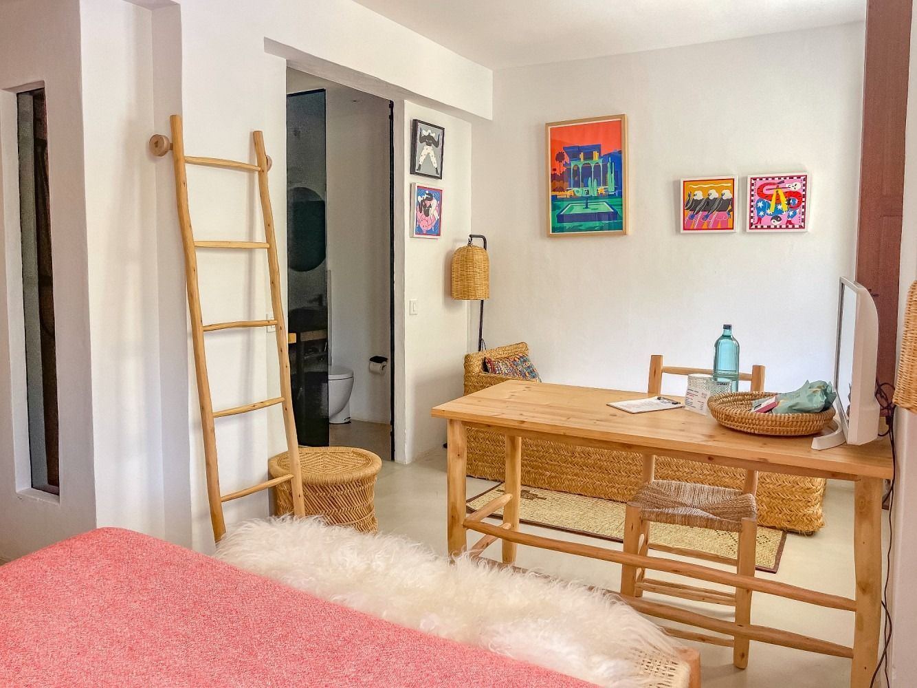 A living room with a wooden table and chairs and a ladder.