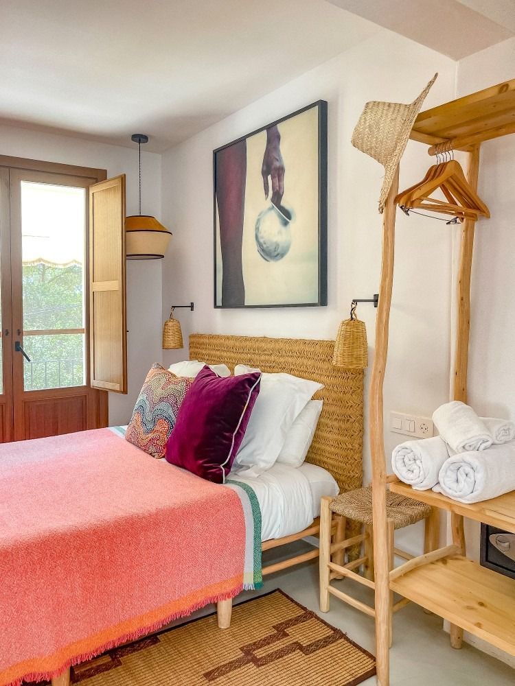 A bedroom with a bed and a picture on the wall