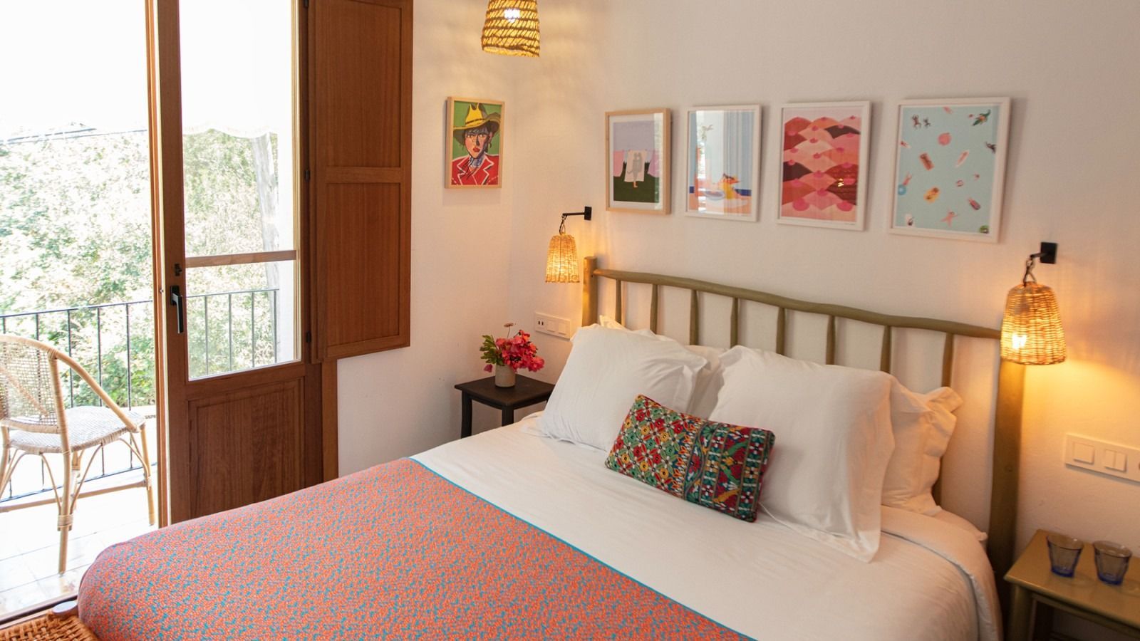 A bedroom with a king size bed and a balcony.
