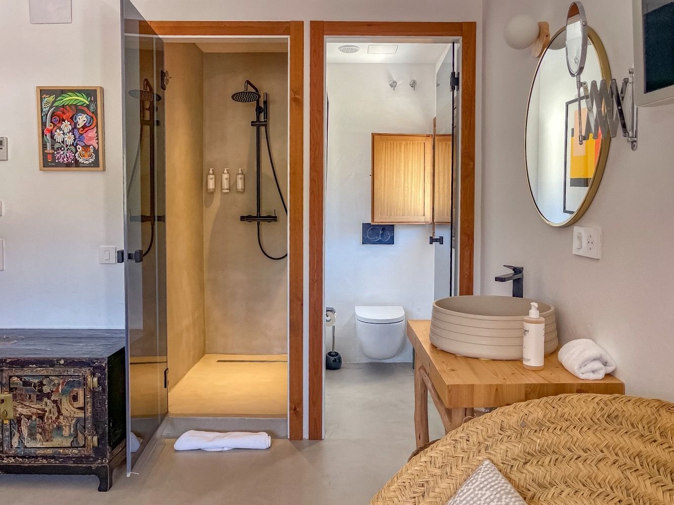 A bathroom with a sink , toilet , shower and mirror.