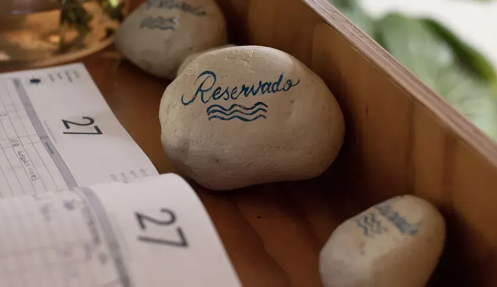 A wooden box filled with rocks and a calendar.