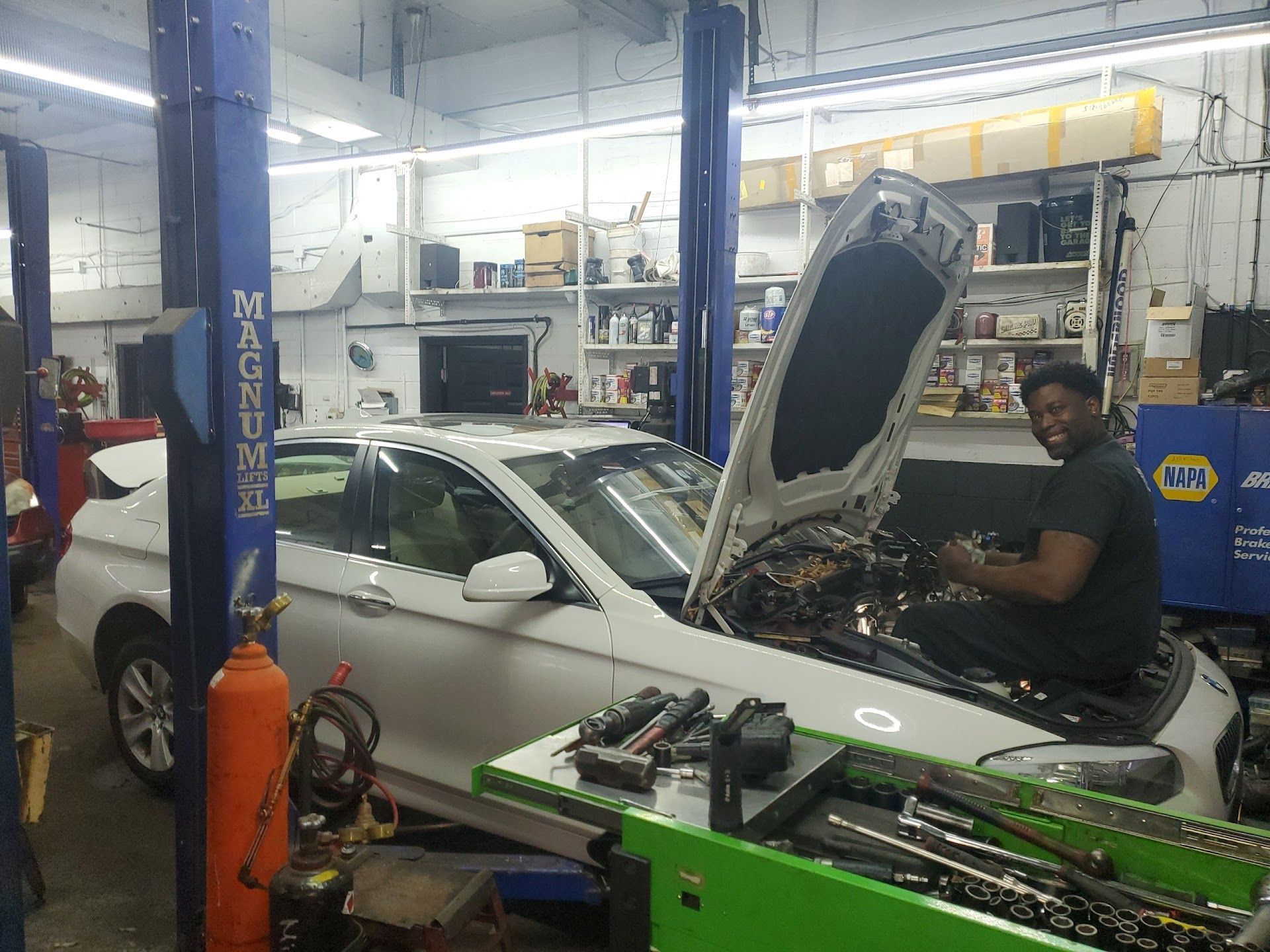 Mechanic Repairing Car With Hood Open | Eric's Premier Auto Center