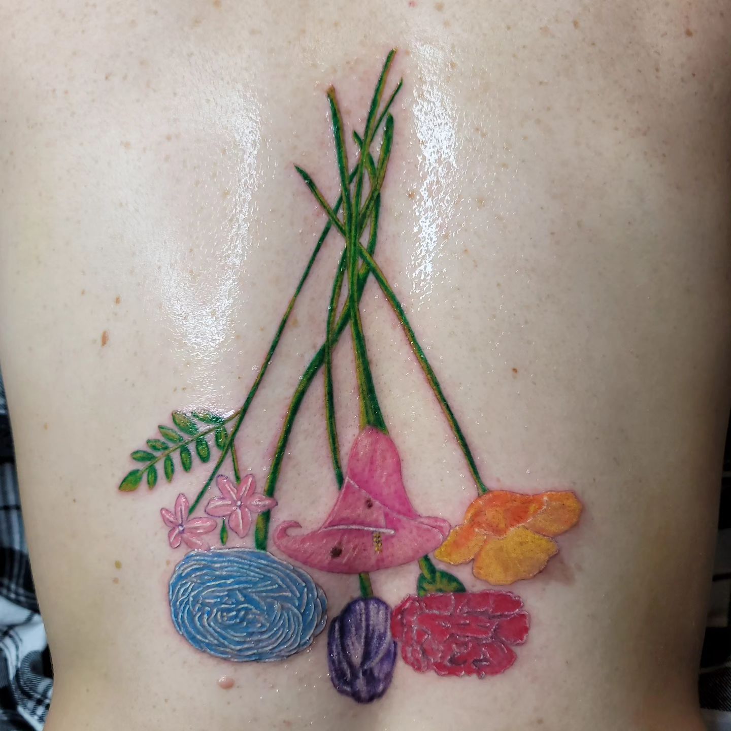 A person is getting a tattoo on their arm.
