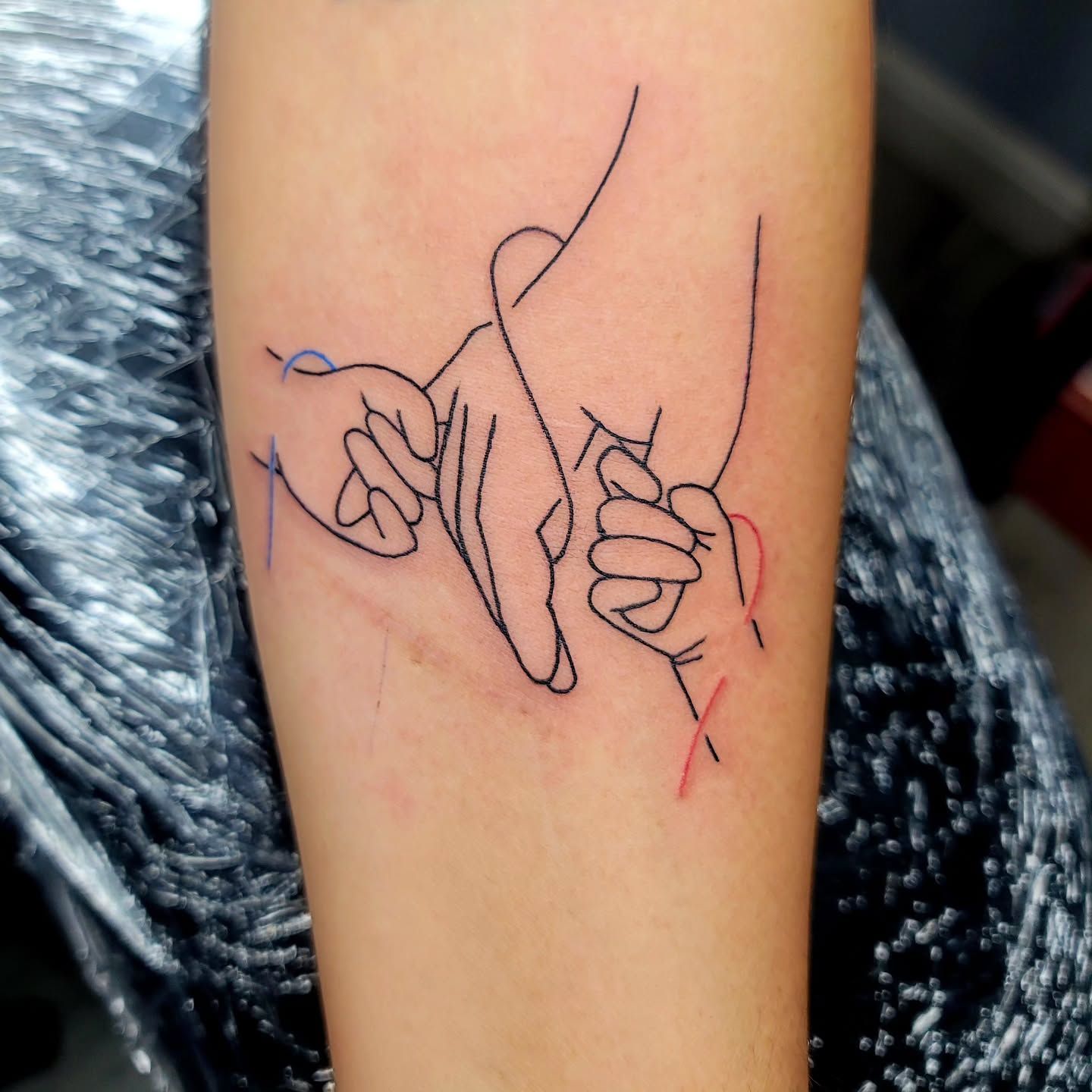 A woman has a small tattoo of a bird on her neck.