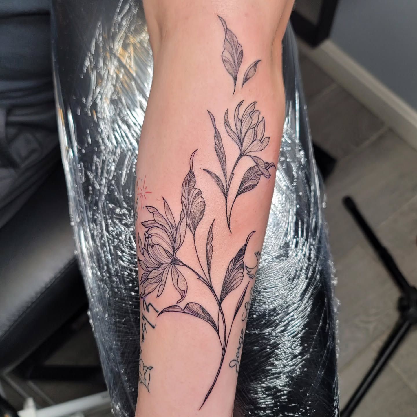 A man with a tattoo on his arm has his arms crossed