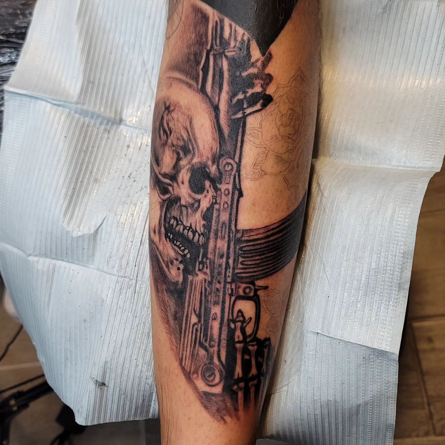 A person is getting a tattoo on their shoulder.