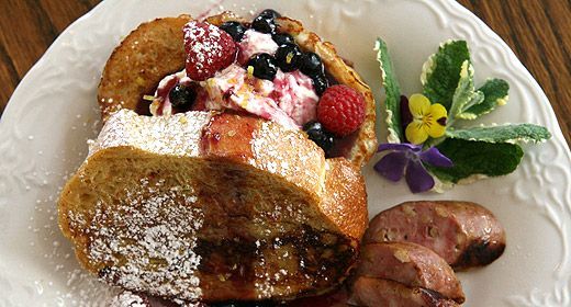 A white plate topped with french toast and berries.