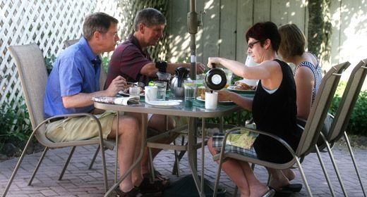 A group of people are sitting at a table outside
