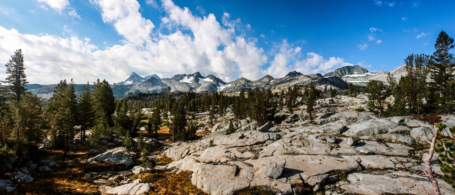 There are mountains in the background and trees in the foreground.