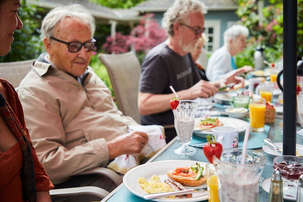 A group of people are sitting at a table eating food.