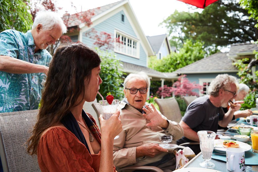 A group of people are sitting at a table eating food.