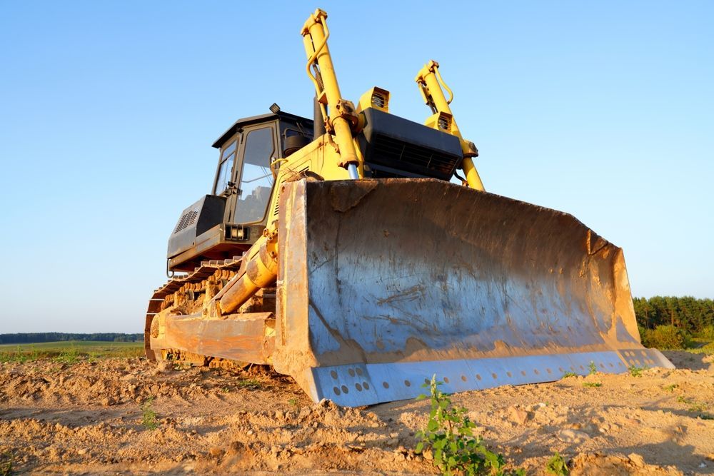 Yellow Bulldozer on a Dirt Field, Under a Clear Blue Sky — Slash Mulch Co in Googa Creek, QLD