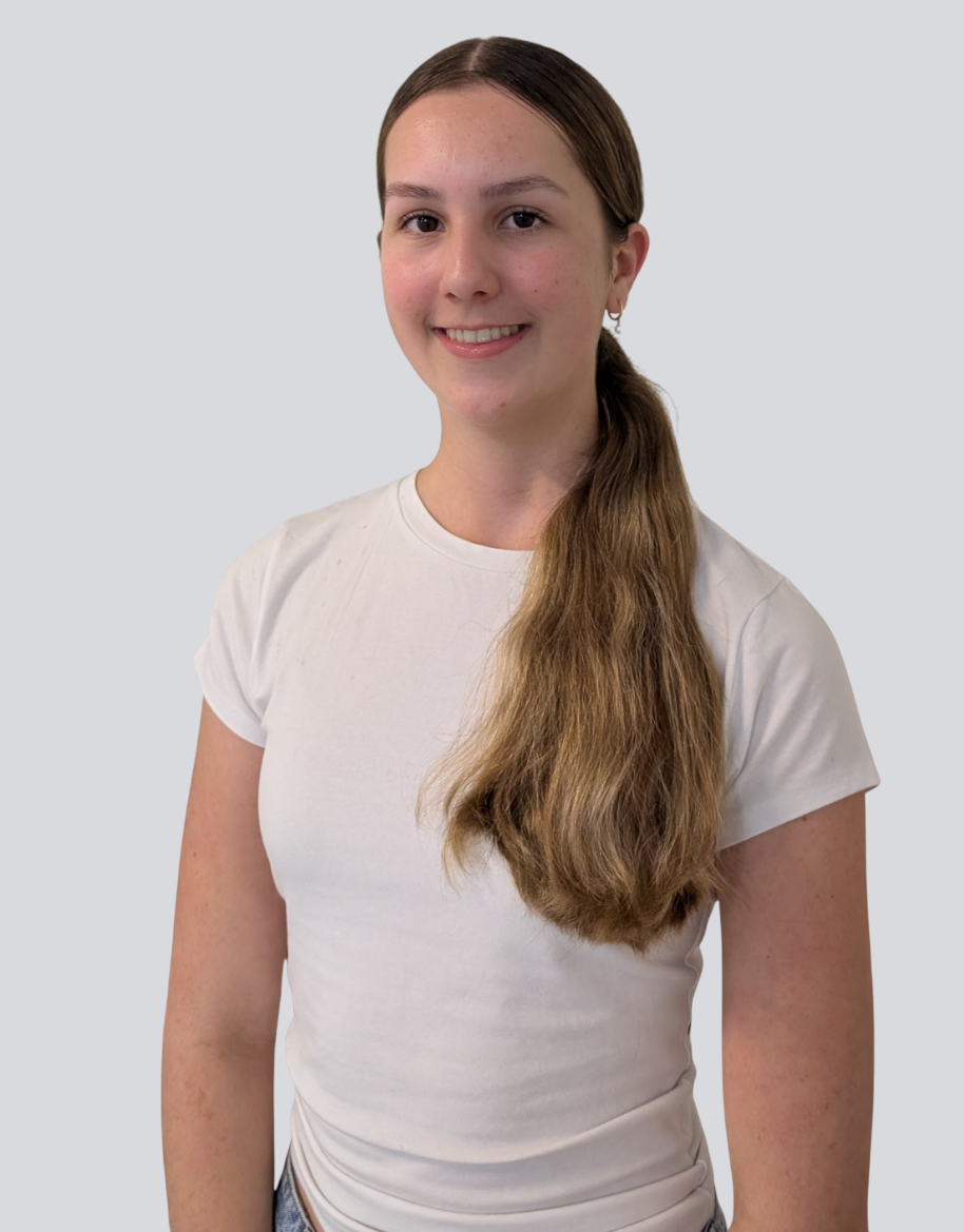 The girl is wearing a white t-shirt and a ponytail.