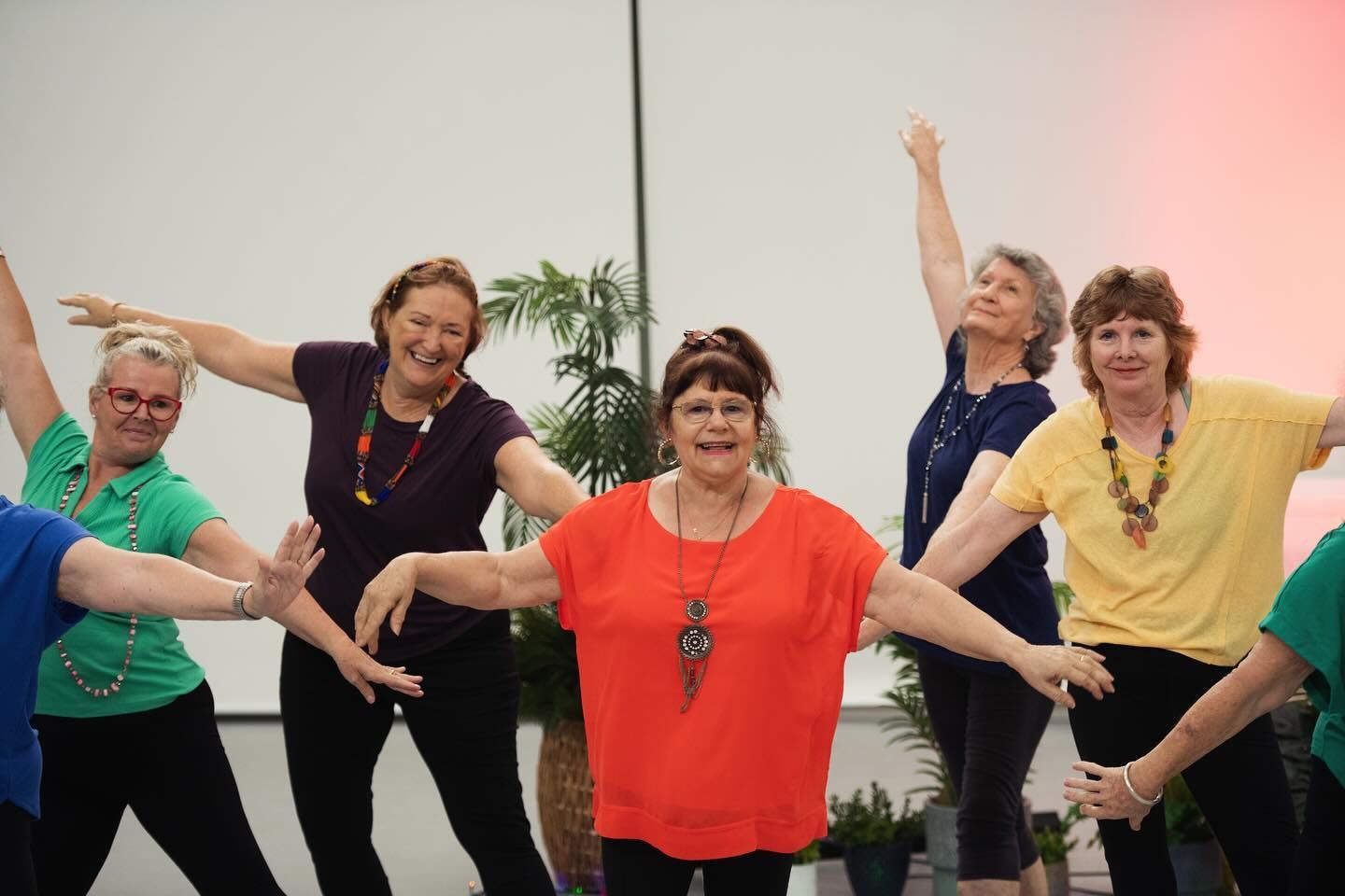 A group of women are dancing together in a room.