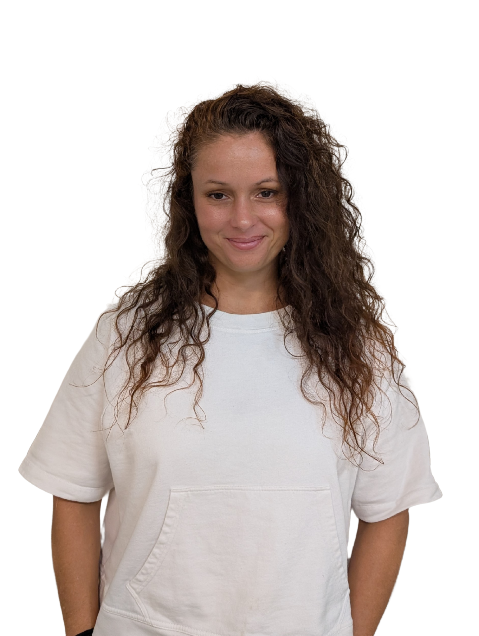 A woman with curly hair is wearing a white shirt and smiling.