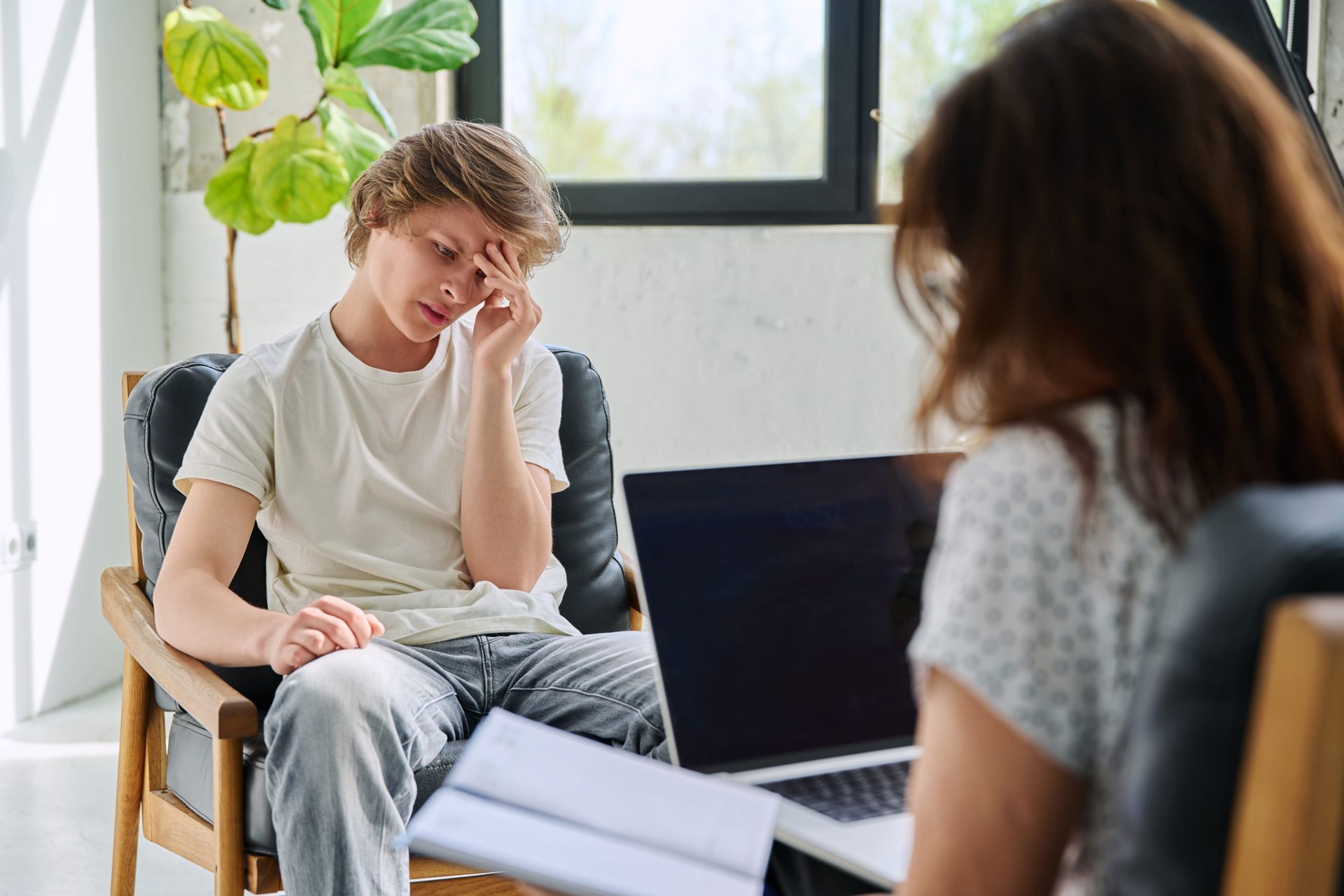 Teen talking with a counselor in a calm, welcoming Centreville, VA office during anxiety therapy
