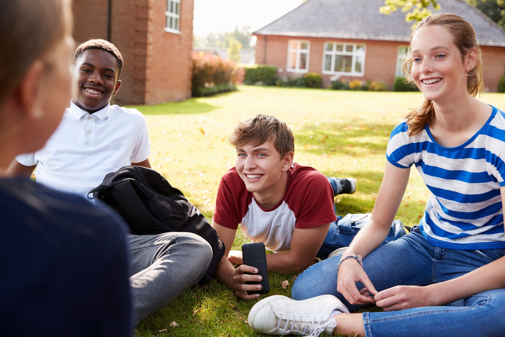 Group of homeschooled teens talking together outdoors, illustrating homeschool socialization