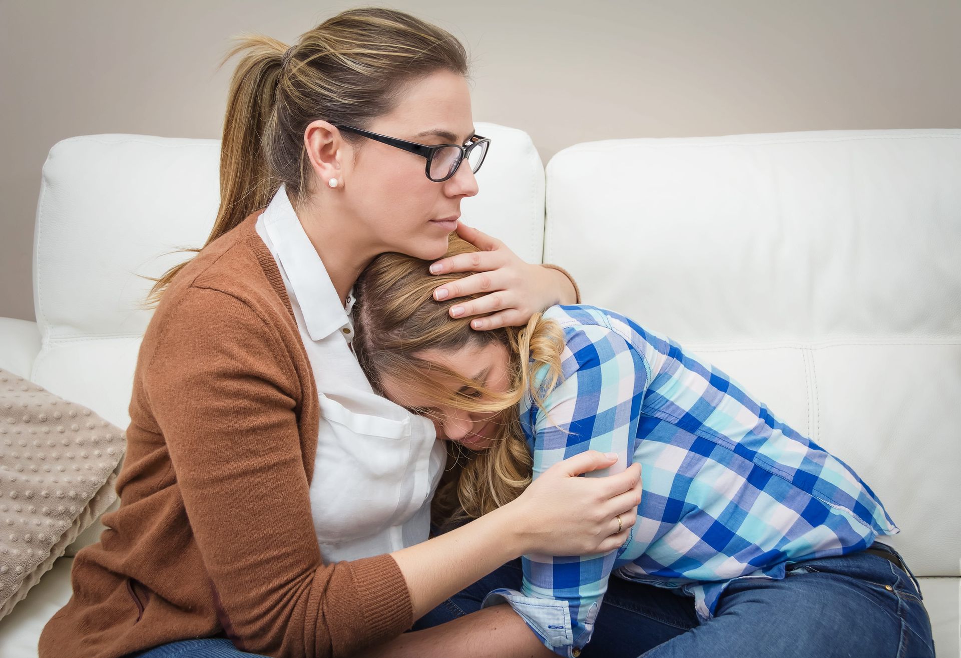 Parent comforting an anxious teenager, illustrating how to help a teen manage anxiety in Centreville