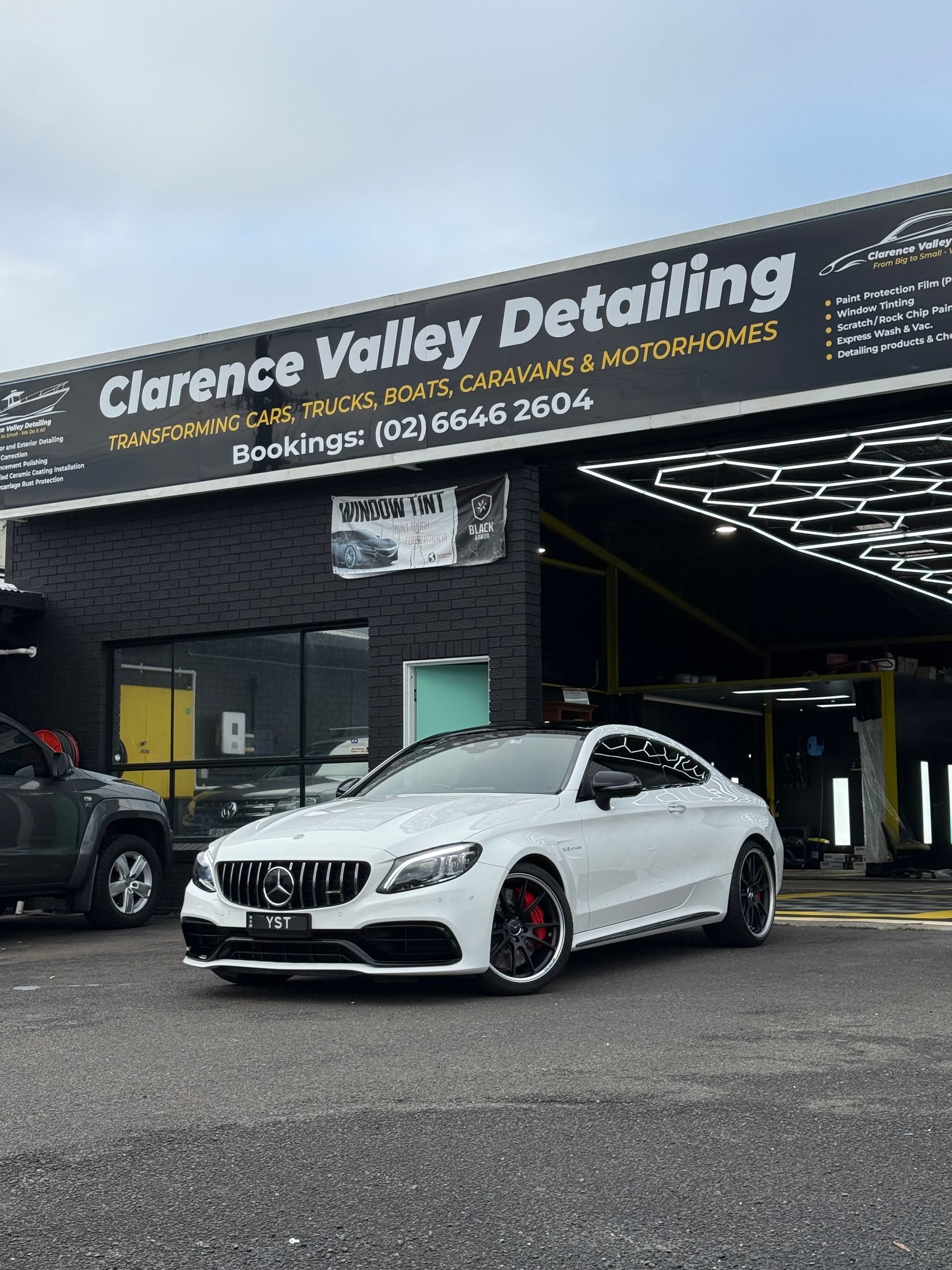 Silver Mini Cooper Covered in White Car Wash Foam Outdoors — Clarence Valley Detailing In Woolgoolga, NSW