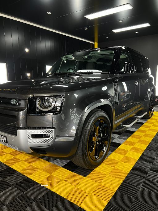 A Gray Land Rover Defender is Parked in a Garage — Clarence Valley Detailing In Yamba, NSW