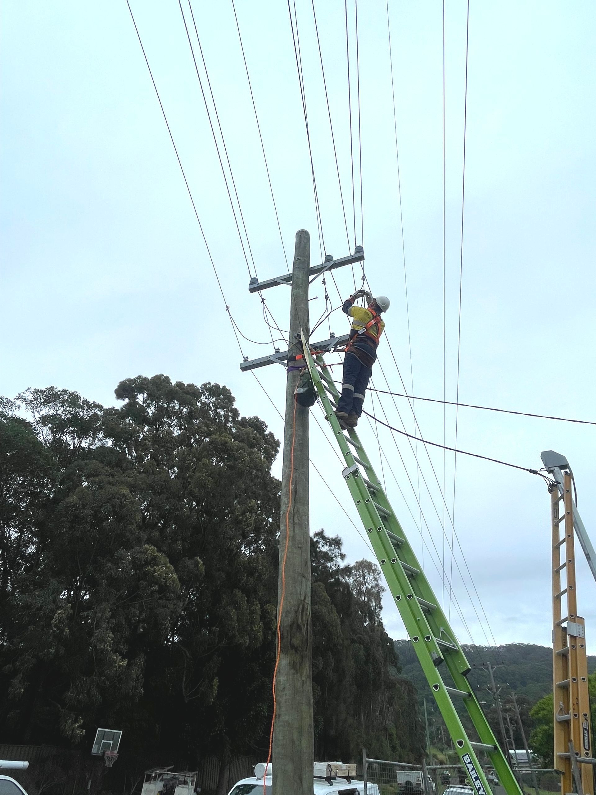 Electrician Working On An Electrical Panel At Night — Luke Jones Electrical In Bellambi, NSW
