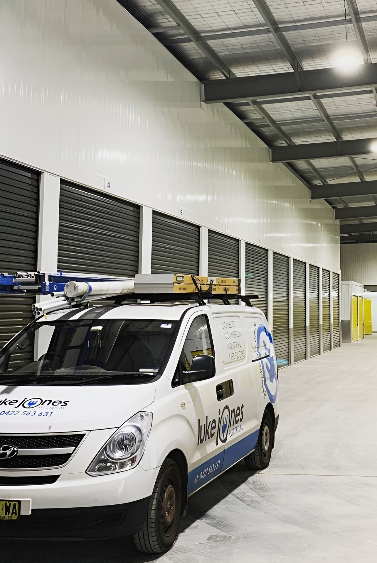 A Work Van Inside Storage Facility — Luke Jones Electrical In Thirroul, NSW