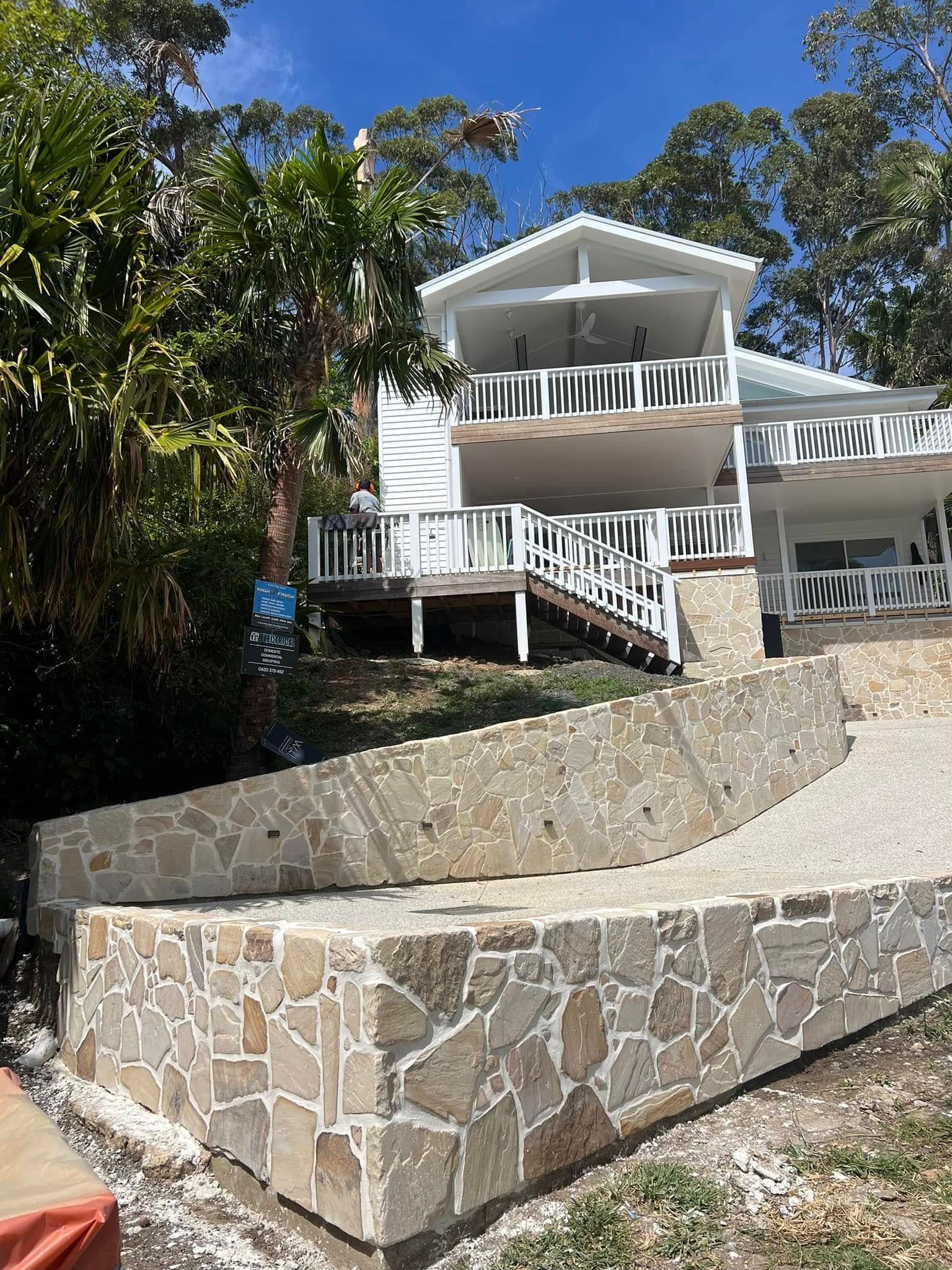 A Brick Walkway Leading To A Lush Green Field — Southern Bricks & Pavers In Ulladulla, NSW