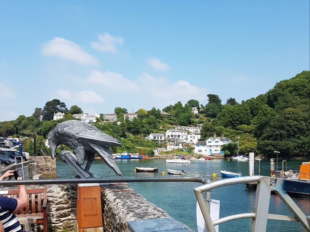 View up river from the Fowey side towards Bodinnick village scrambling up the opposite bank with the Rook sculpture