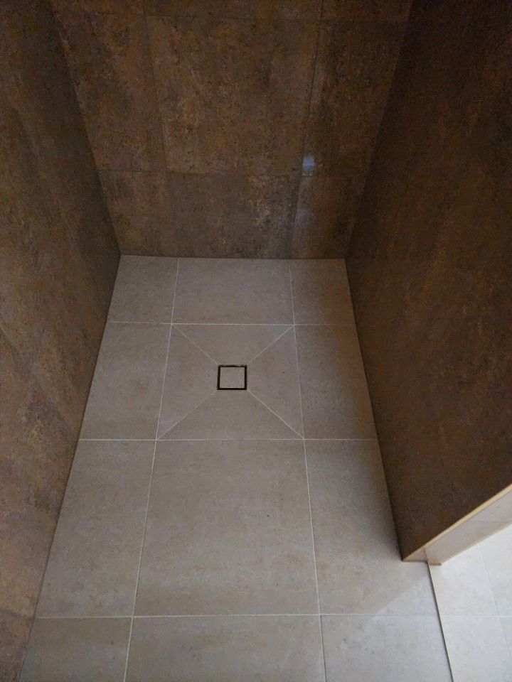 A Shower Floor Featuring Light Beige Square Tiles — Done Right Bathrooms And Renovations in Edmonton, QLD