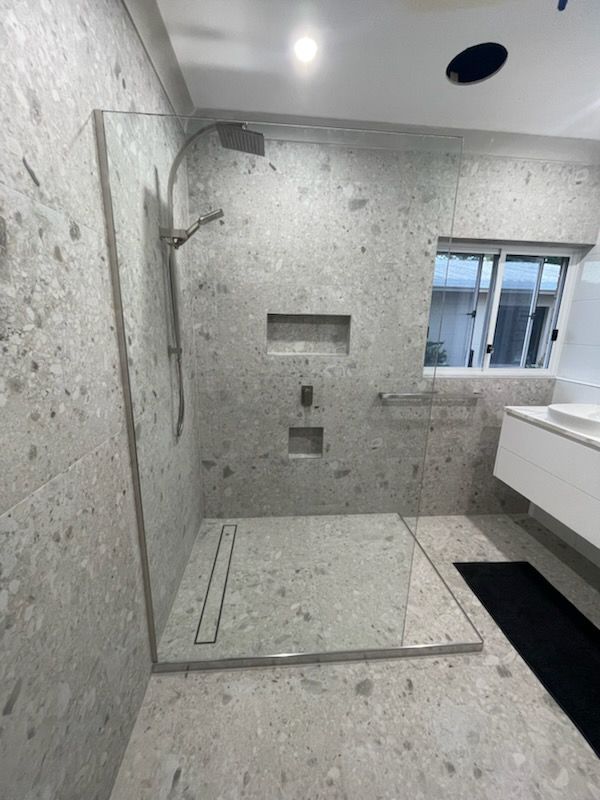 Modern Stone-tiled Bathroom With Walk-in Shower — Done Right Bathrooms And Renovations in Edmonton, QLD