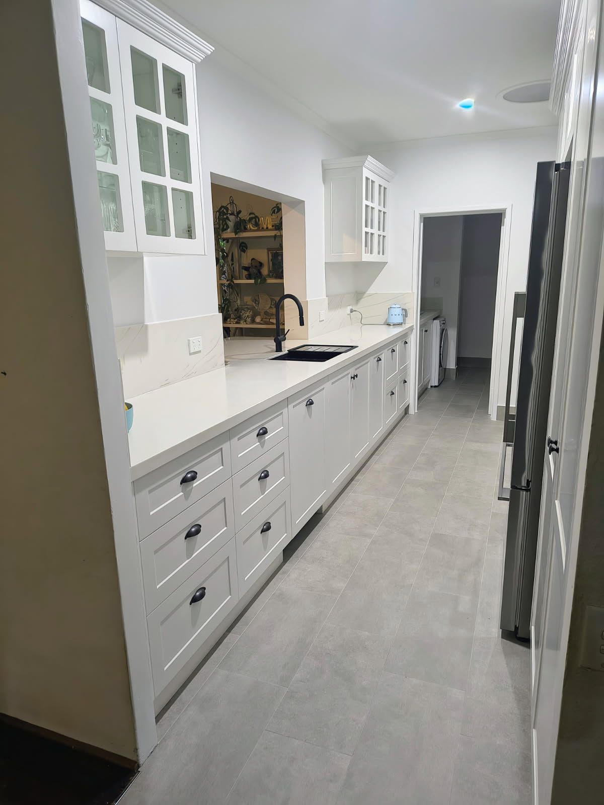 Bright White Kitchen With Long Countertop — Done Right Bathrooms And Renovations in Edmonton, QLD