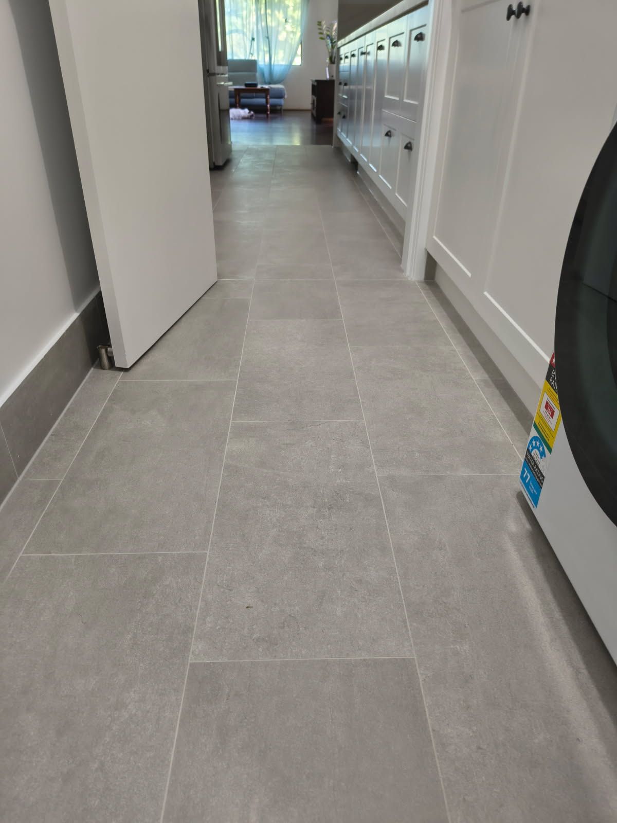 A Hallway With Light Gray, Rectangular Floor Tiles — Done Right Bathrooms And Renovations in Edmonton, QLD