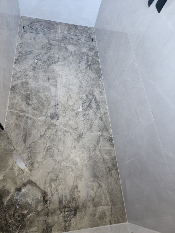A High-angle View Of A Tiled Shower Floor — Done Right Bathrooms And Renovations in Edmonton, QLD