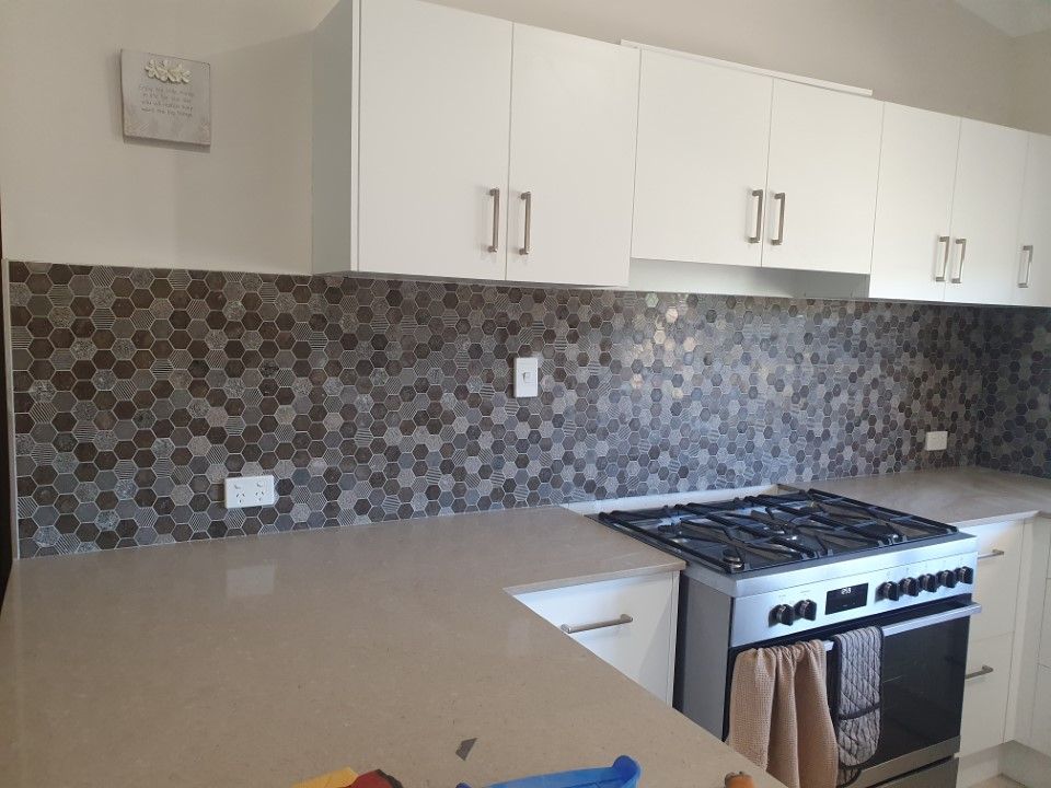 Modern Kitchen With Cabinets, Countertops, and a Gas Stove — Done Right Bathrooms And Renovations in Edmonton, QLD