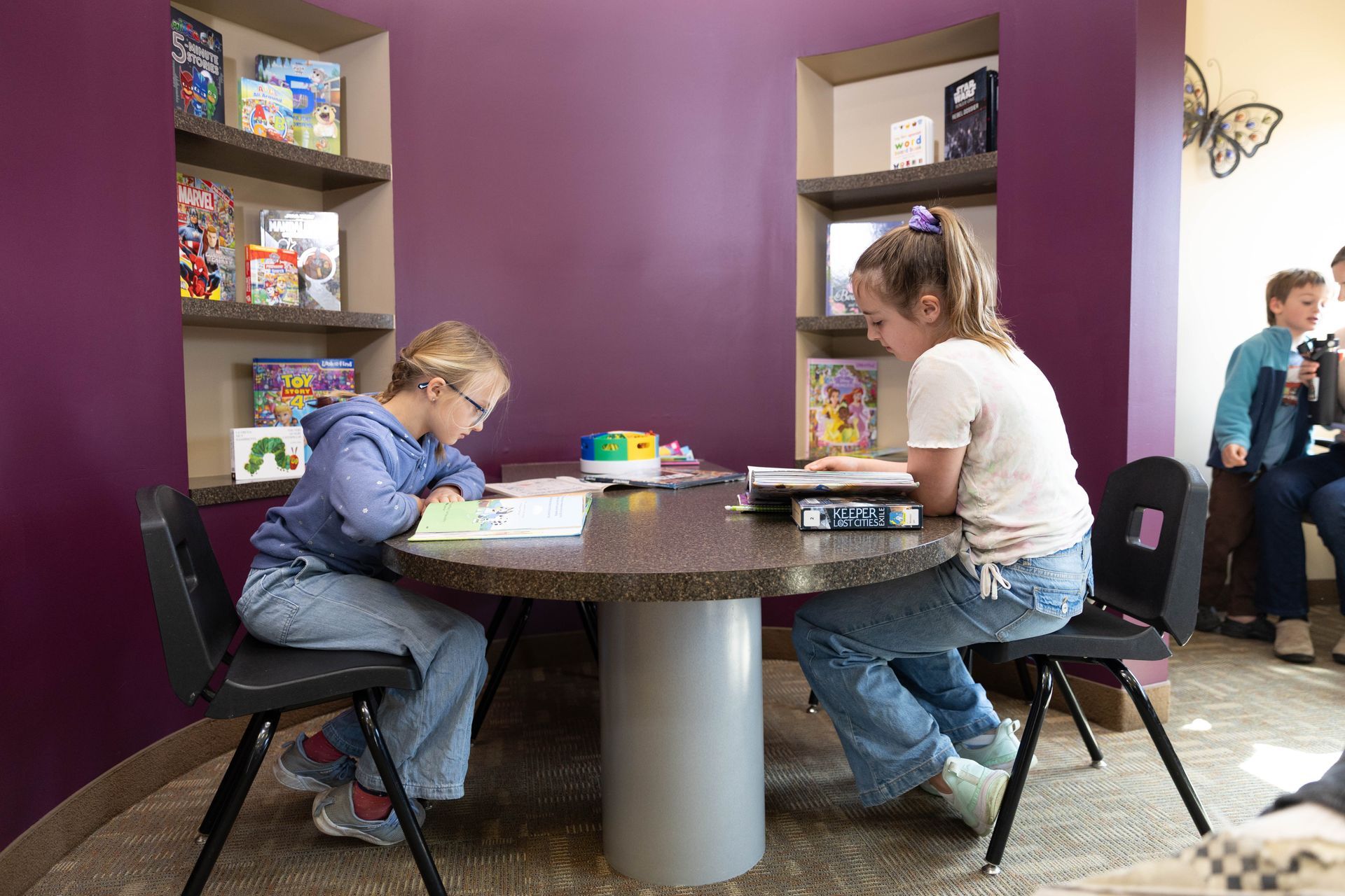 Two children reading in the Tooth Town book nook