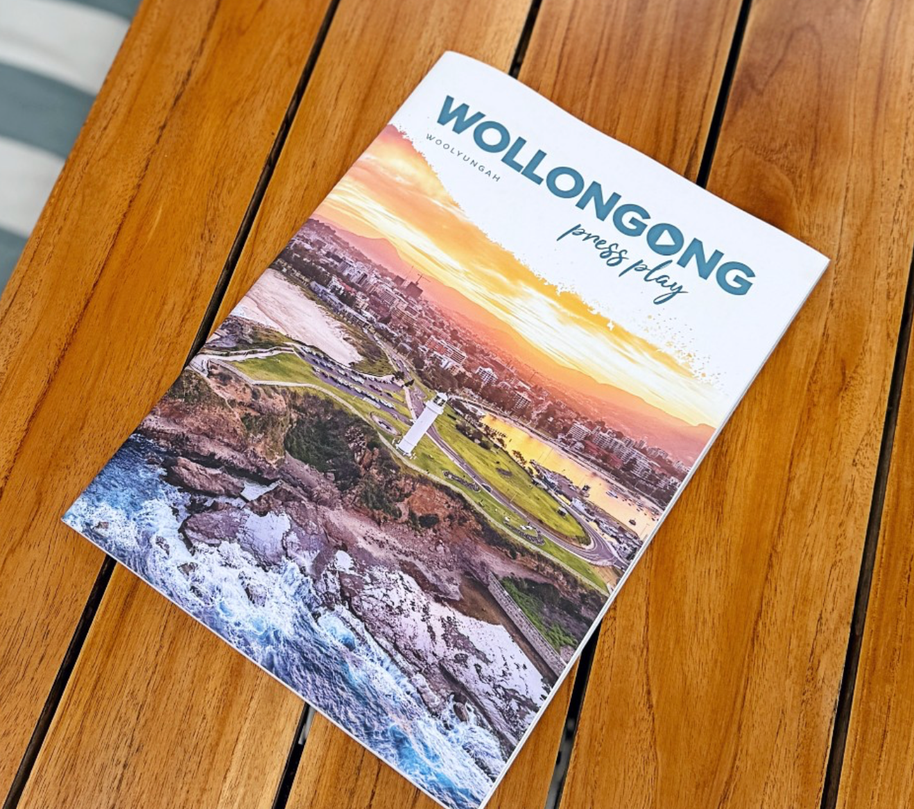 A book titled wollongong is sitting on a wooden table