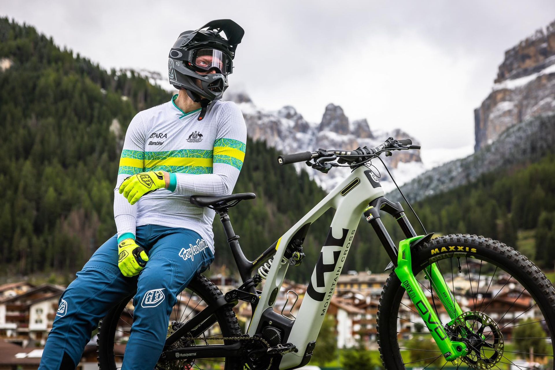 A man is sitting on a mountain bike in the mountains.