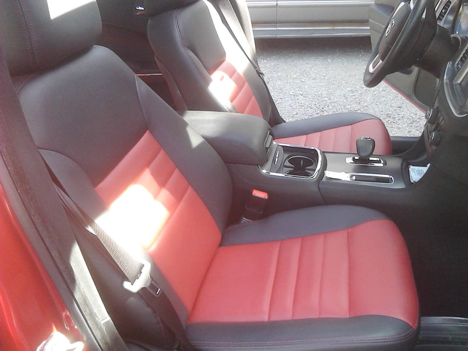 The interior of a red car with black and red seats