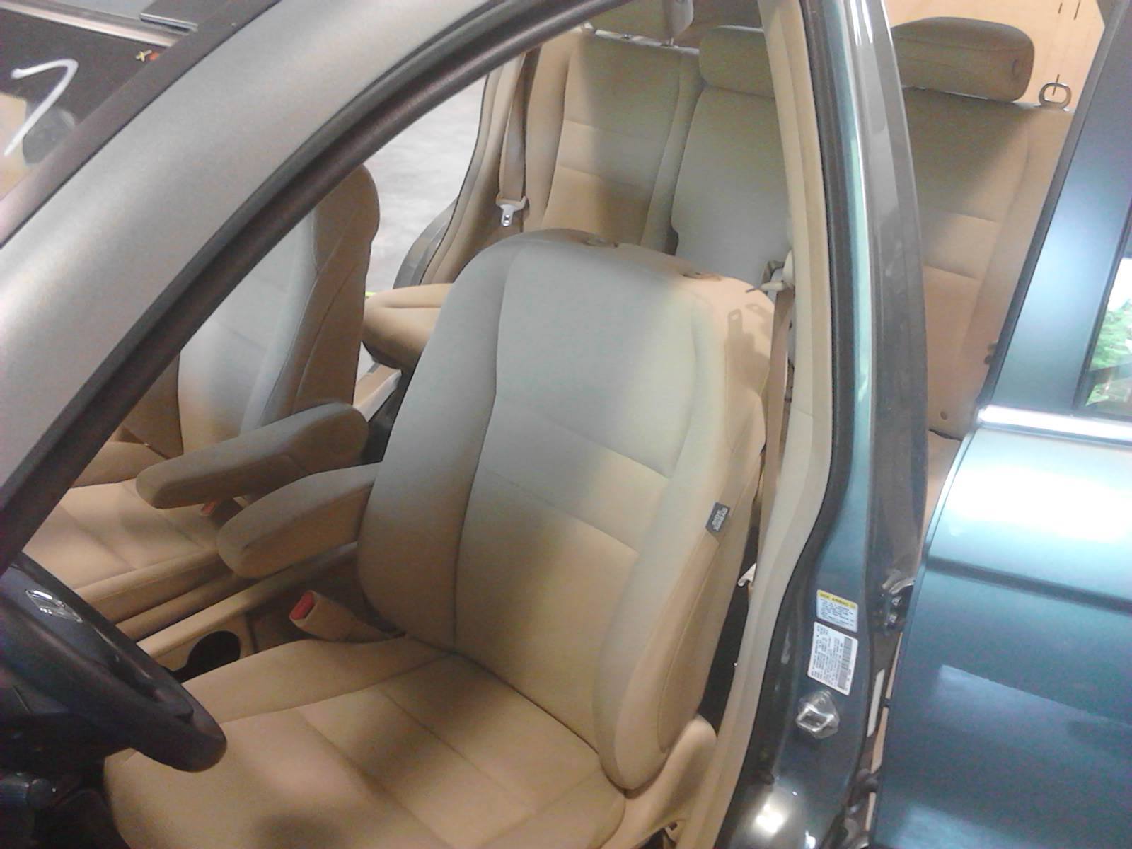 The inside of a car with the door open showing the seats