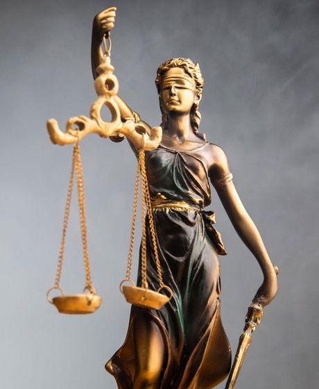 Statue of Lady Justice with scales and a sword, blindfolded.