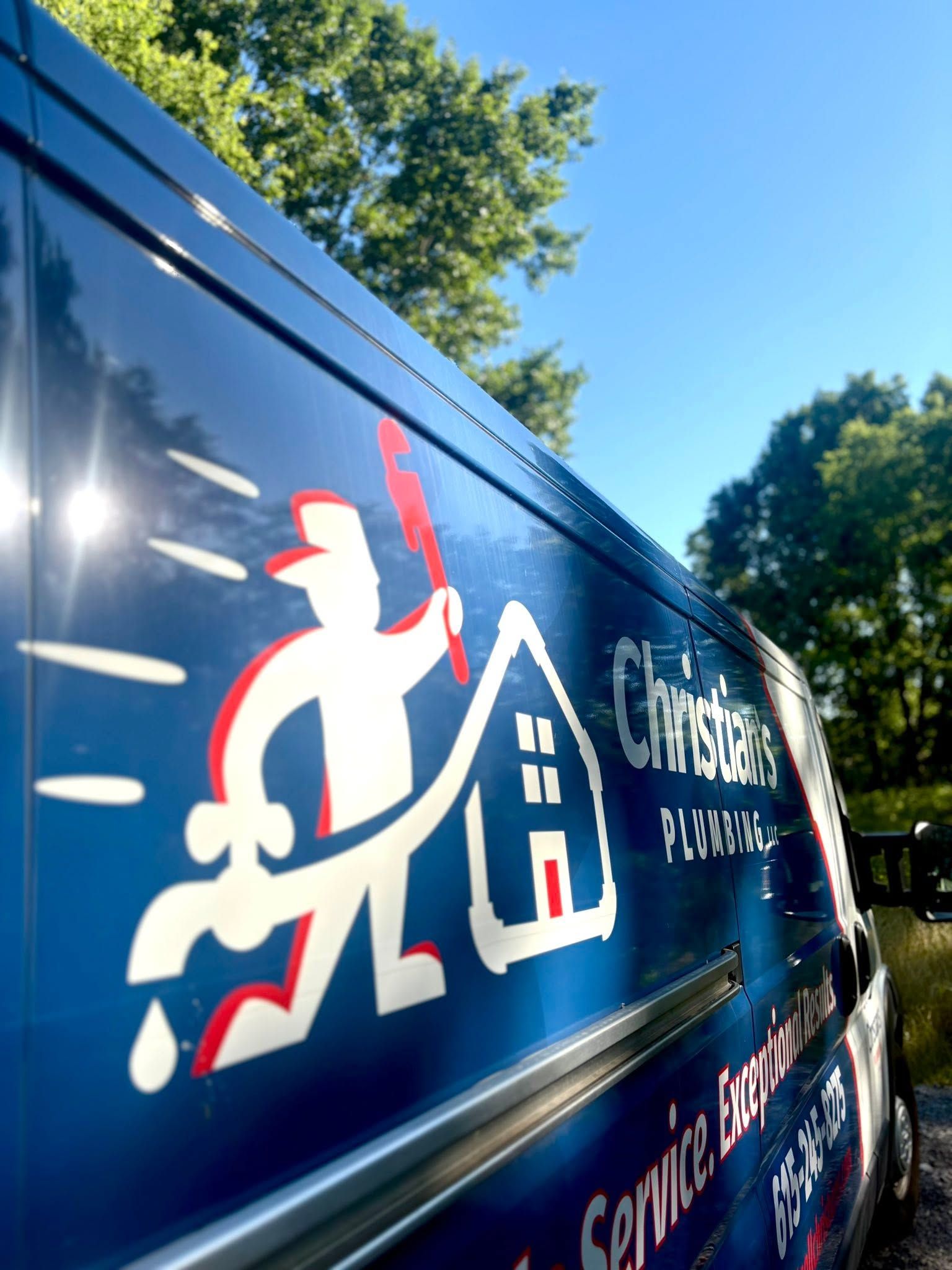 Blue service van with white-and-red logo and text, parked outdoors under a sunny sky