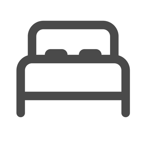 Un icono de una cama con dos almohadas sobre un fondo blanco.