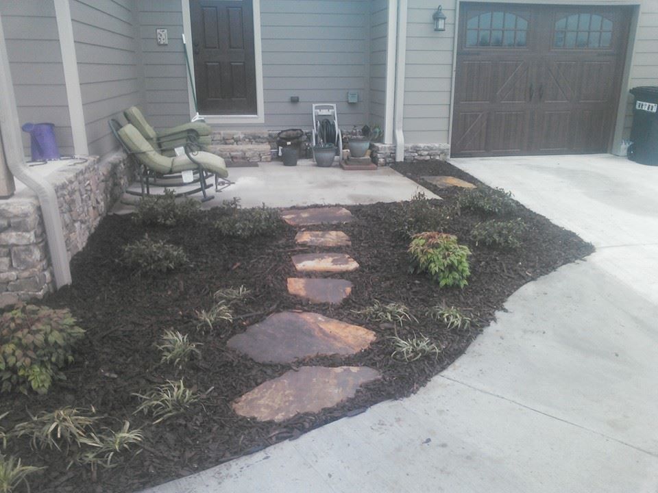 A house with a patio and a walkway leading to it