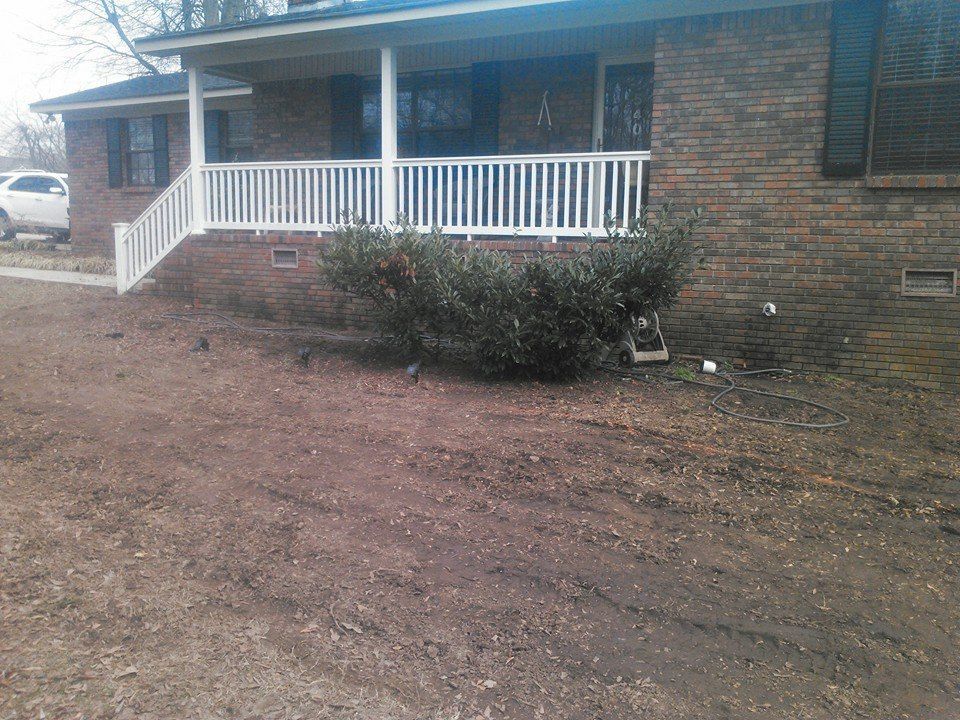 A brick house with a white porch and stairs