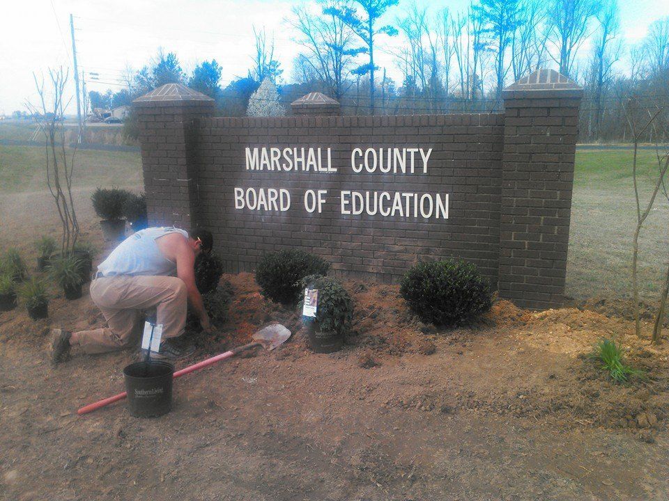 A sign for the marshall county board of education