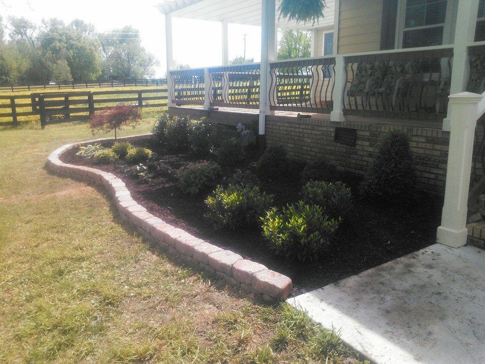 A house with a porch and a fence in the background