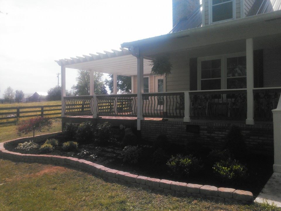 A house with a porch and a fence in the background